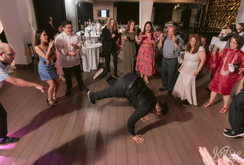 A man does the worm on the dancefloor at a wedding reception at The Vue Event Venue in Toronto