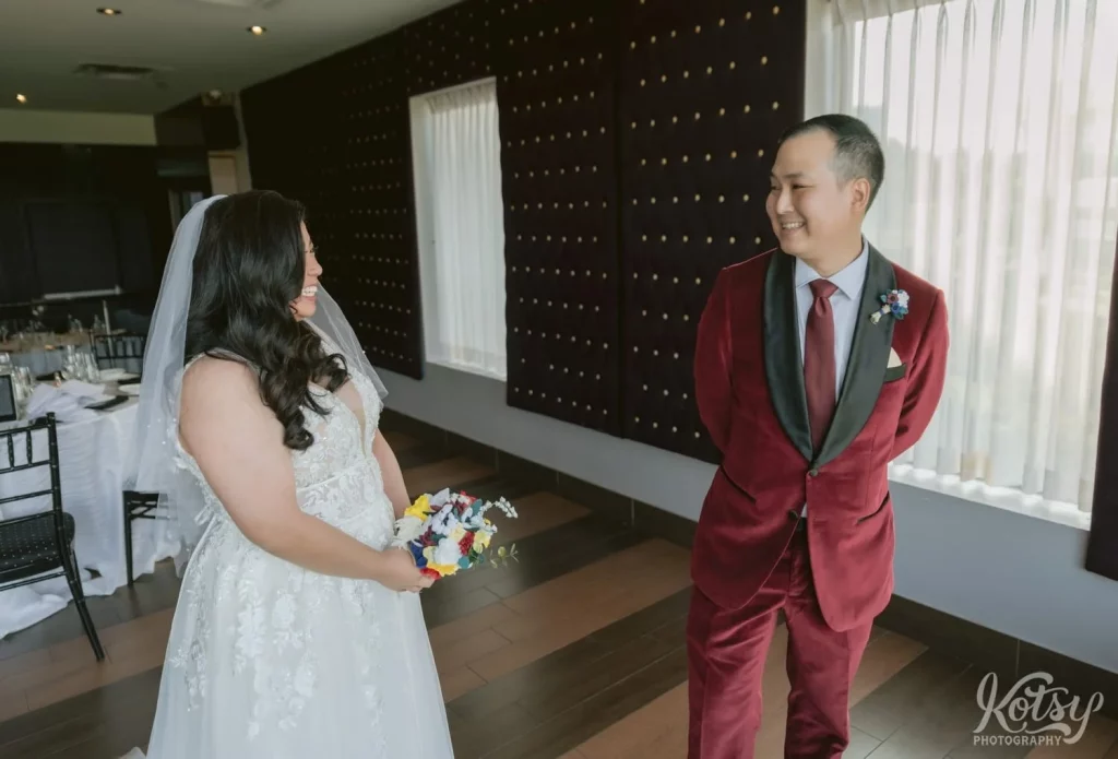 A groom reacts to his bride during a first look at The Vue Event Centre
