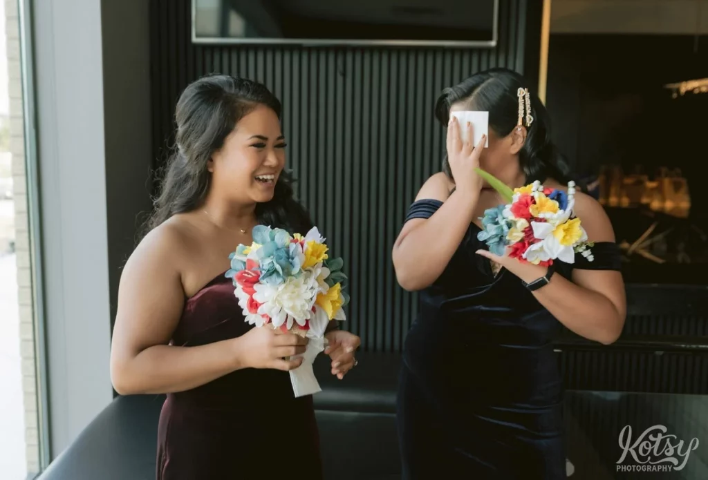 A bridesmaids covers her face as she tears up during a first look at The Vue Event Venue