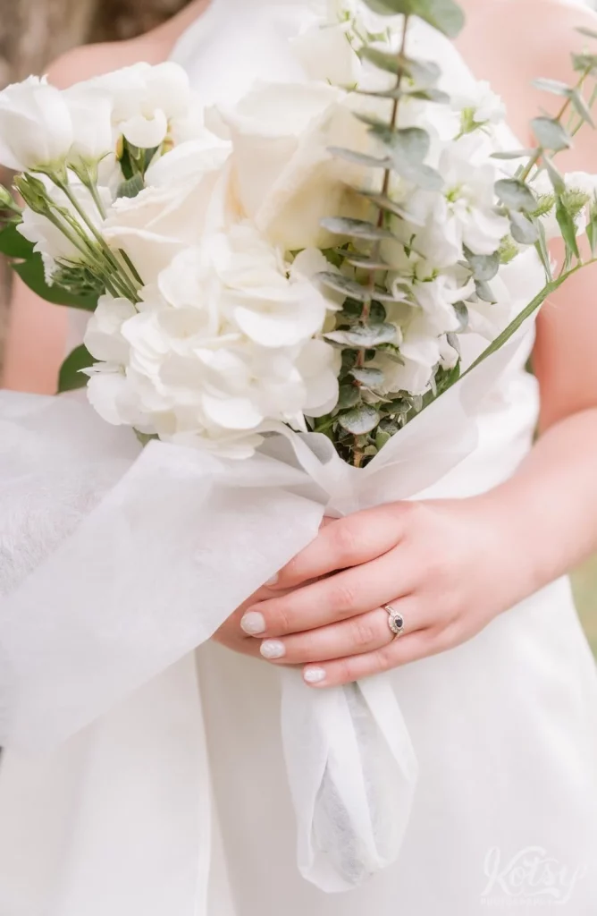 A close up shot of a bride holding a a flower bouquet.