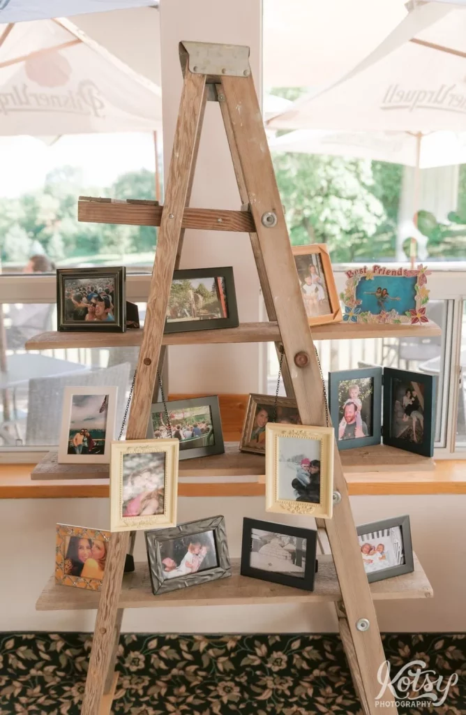 A shot of wooden ladder with framed pictures all over it