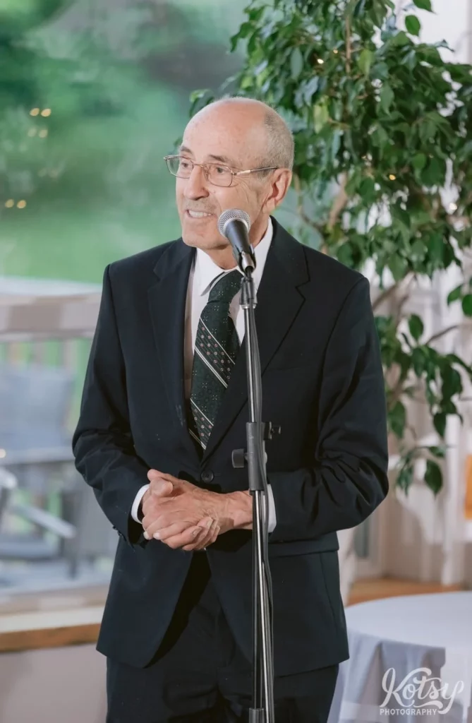 A close up of an elderly man making a speech during a wedding reception at The Prague Restaurant in Scarborough
