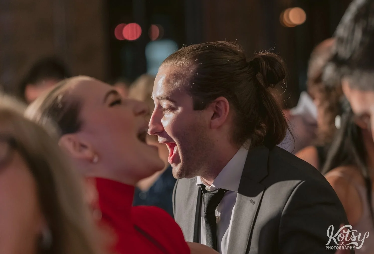 A close up shot of a man and a woman at different distances with their mouth open dancing During a Second Floor Events wedding reception in Toronto, Canada.