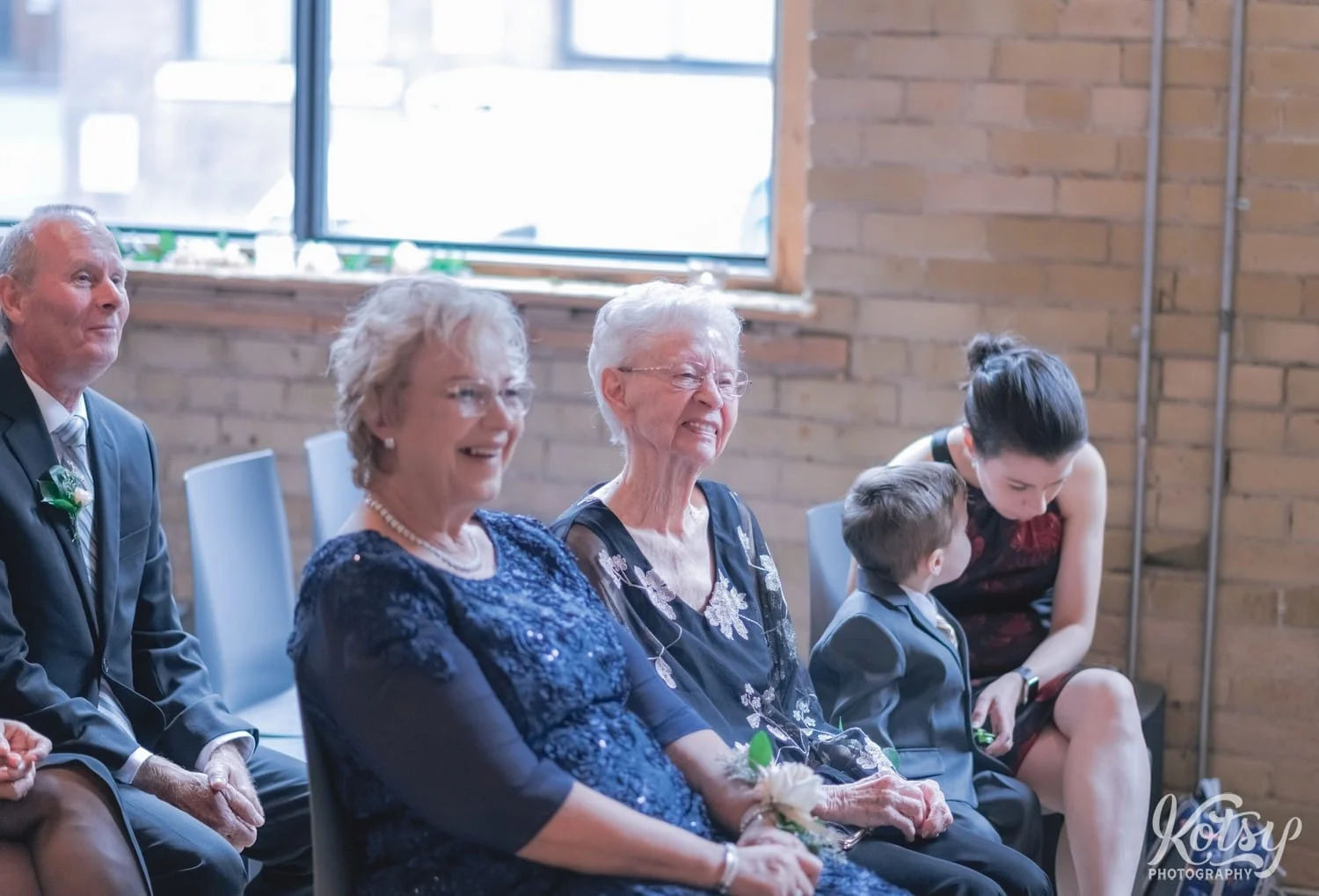 Two elderly woman's look off camera while smiling during a Second Floor Events wedding ceremony in Toronto, Canada