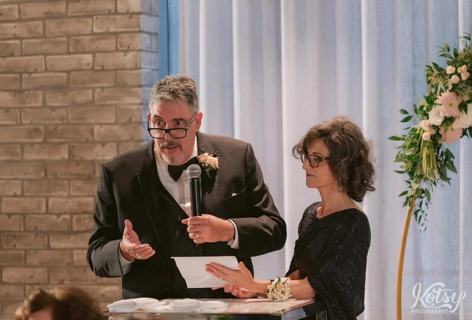 An elderly man makes a speech while standing next to his wife during a Village Loft wedding reception in Toronto, Canada