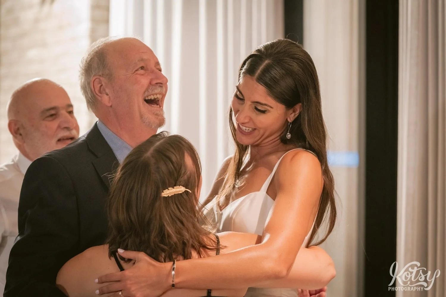 A bride and wedding guest enjoy a laugh during a Village Loft wedding reception in Toronto, Canada