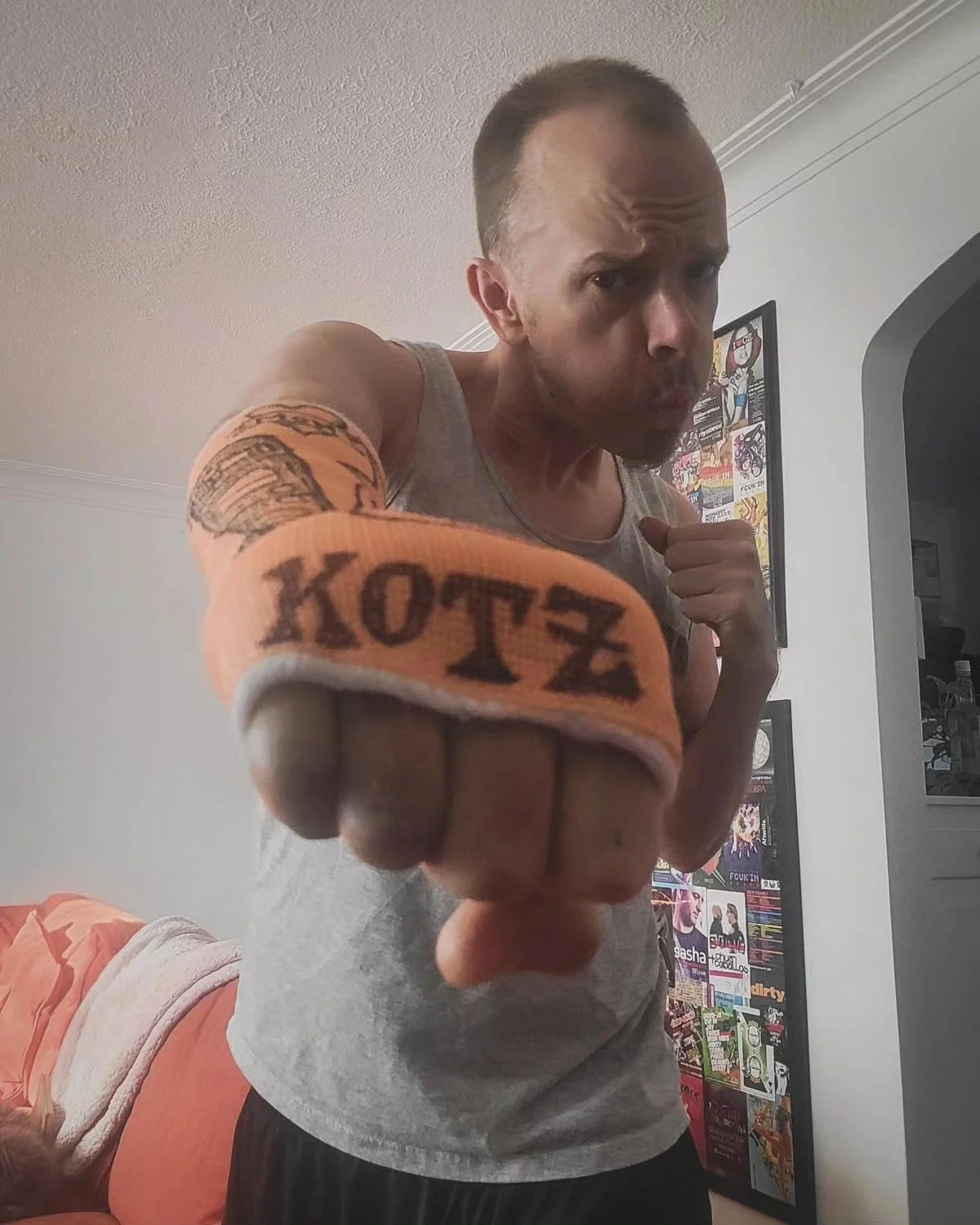 Close up shot of an orange cast over a hand with text reading "Kotz"